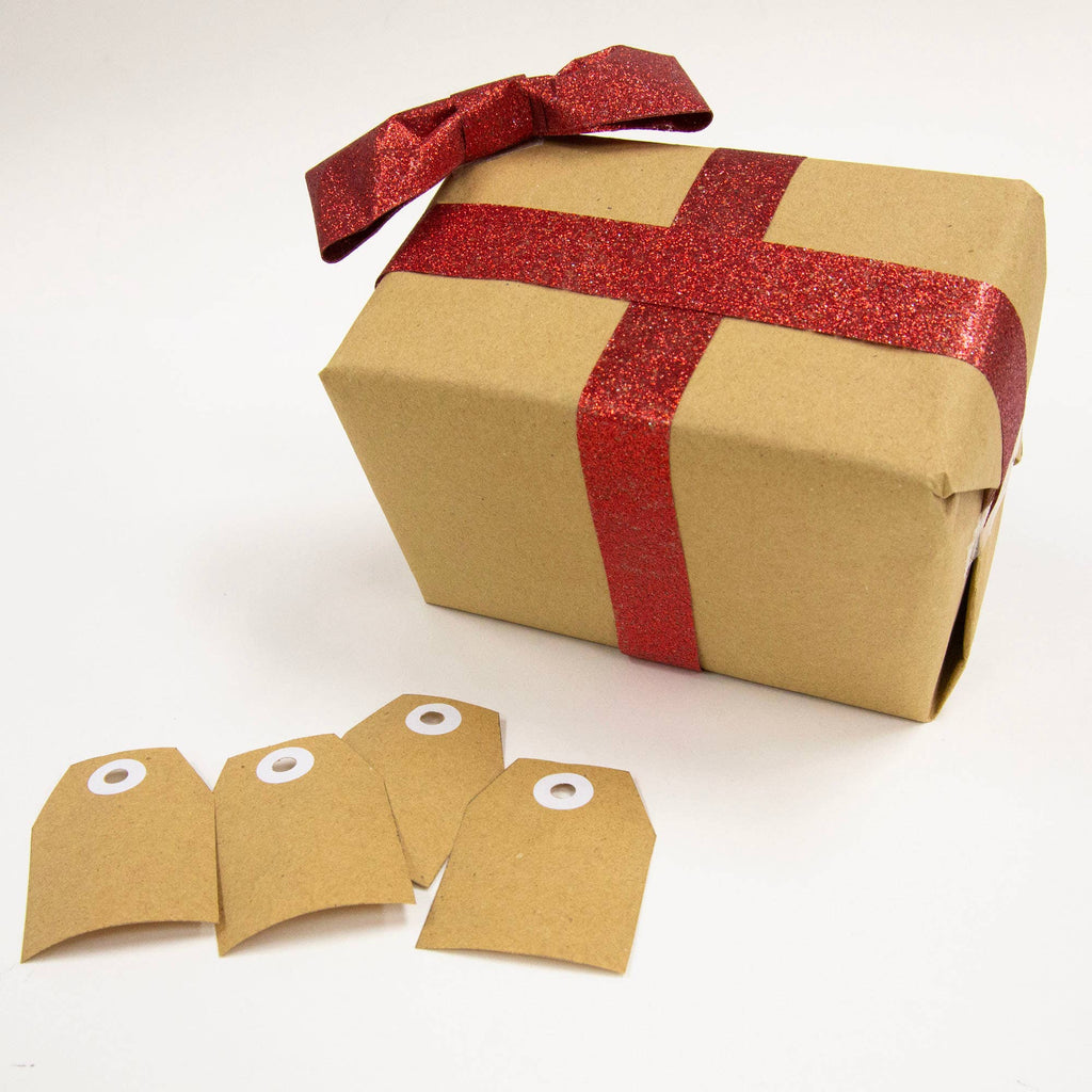 Gift box wrapped in brown paper with a red ribbon and three matching tags on a white background