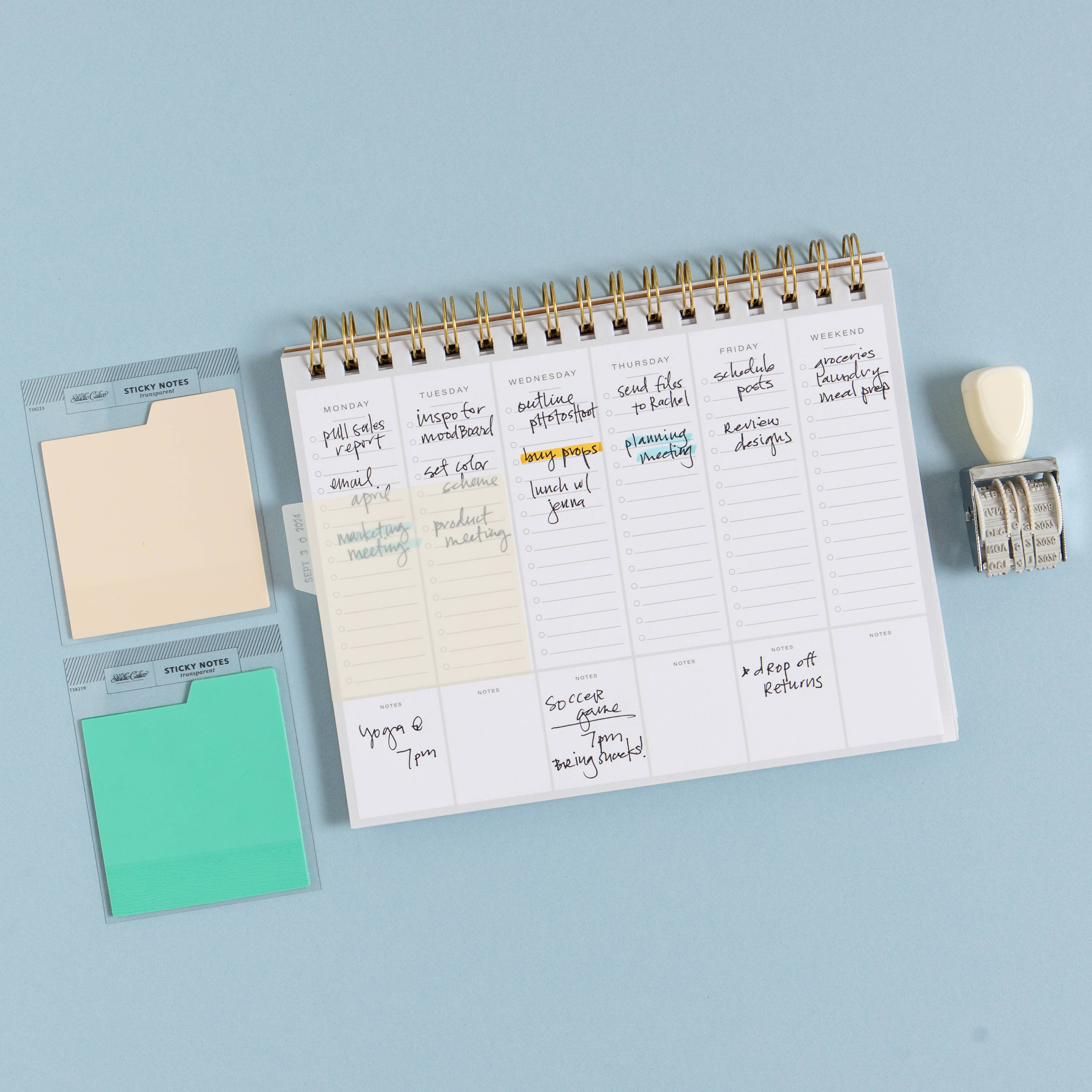 Wired planner with sticky notes on a light blue background