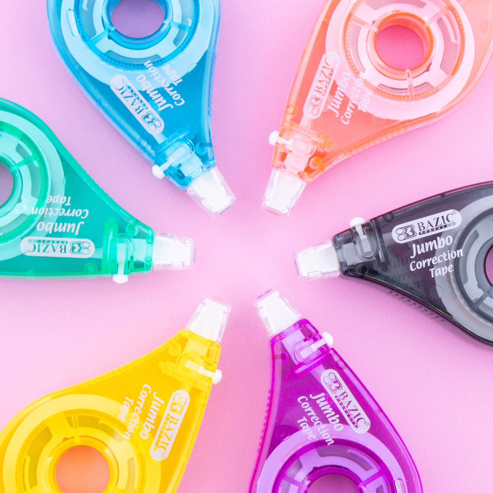 Colorful correction tapes arranged in a circle on a pink background