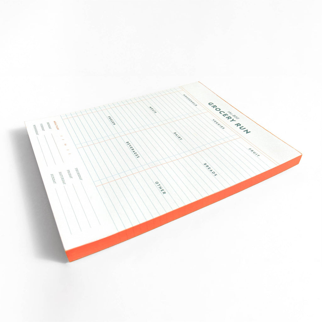 Notepad with a grocery list template on a white background