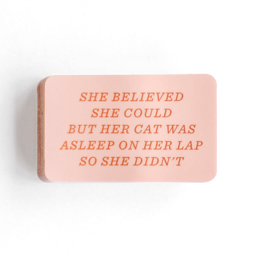 Pink sticker with the text "she believed she could but her cat was asleep on her lap so she didn't"