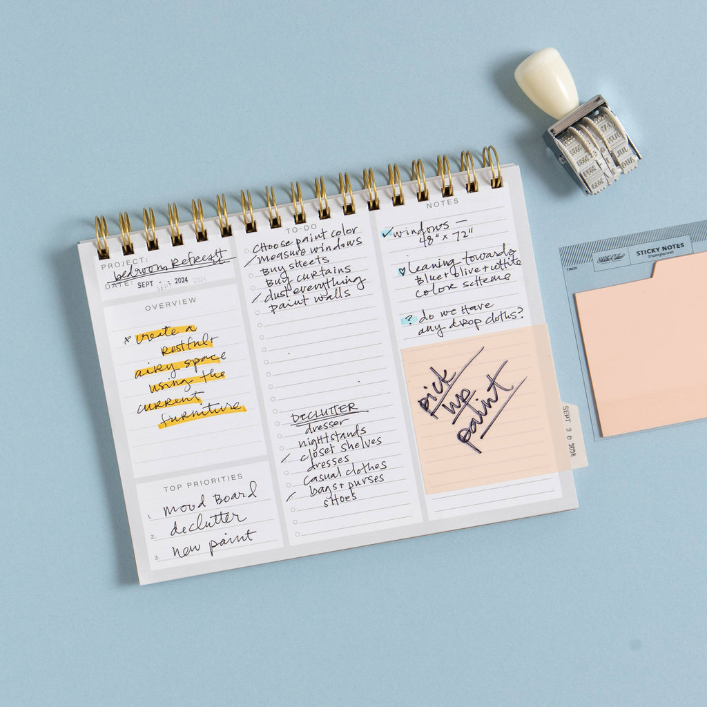Notebook with handwritten notes and a stamp on a light blue background