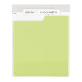 Sheet of green sticky notes with a visible brand label on a white background